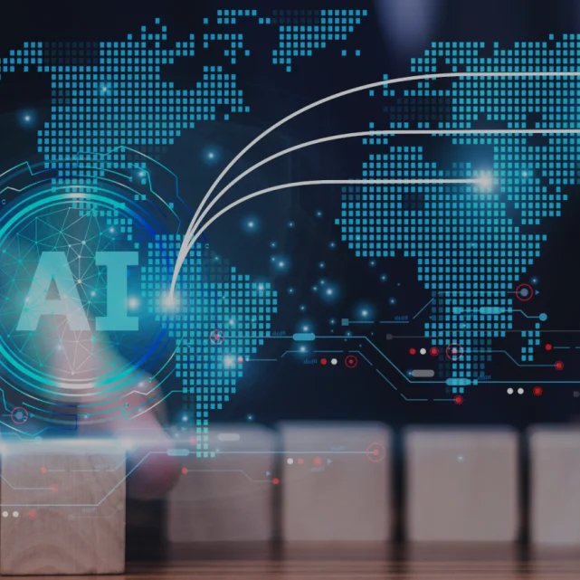 Close-up of a hand placing wooden blocks with a digital overlay of AI and a world map, symbolizing AI-powered global connections.