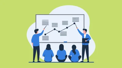 A team presenting a graph to a group on a whiteboard.