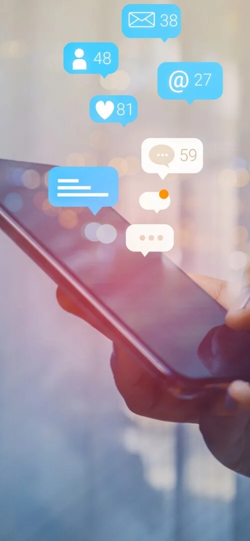 A smartphone displaying a push notification on a website, highlighting user engagement through progressive web solutions. The device is set against a clean white background.