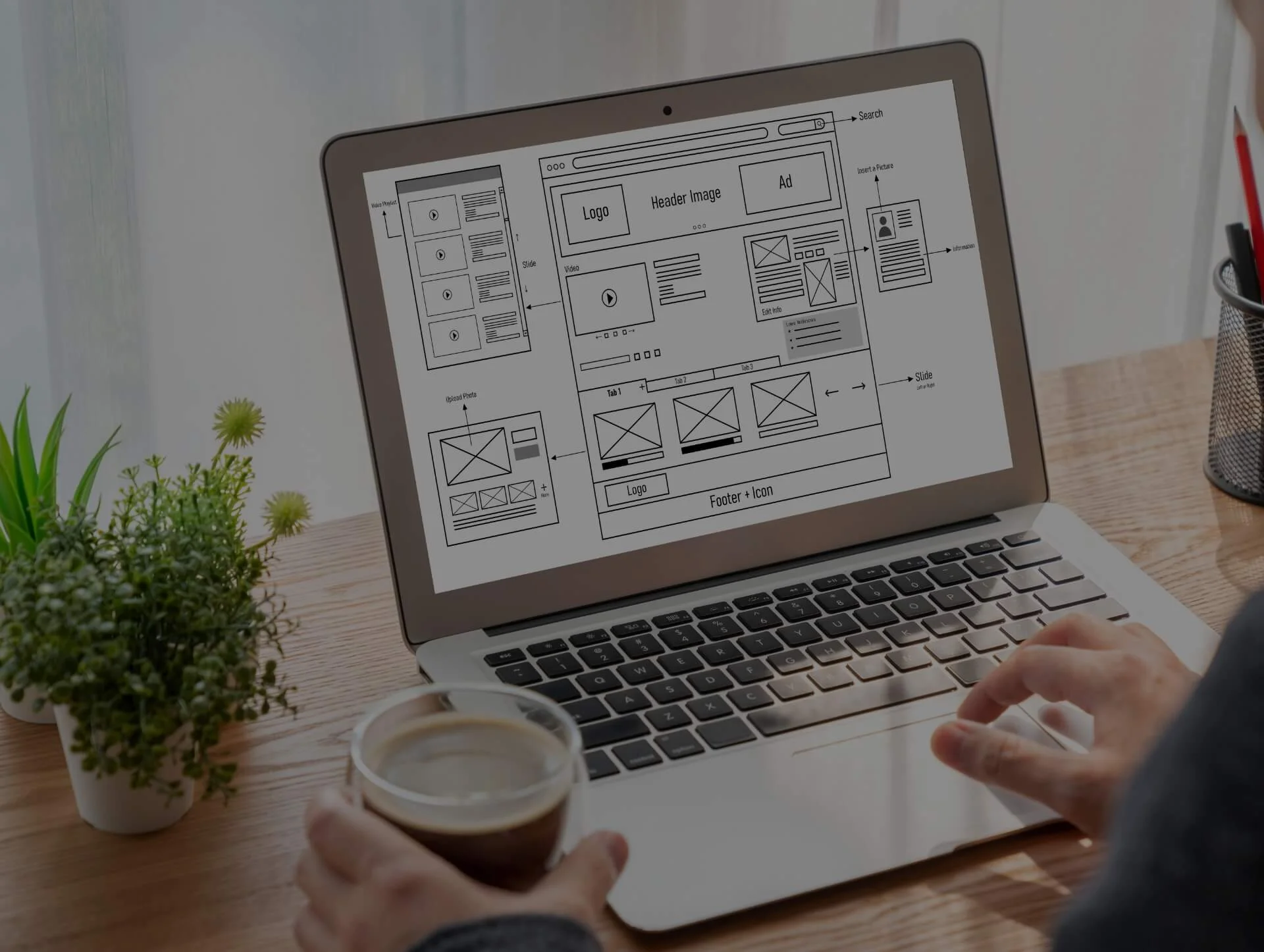 Design and development services for corporate websites (B2B) displayed through a wireframe design on a laptop screen