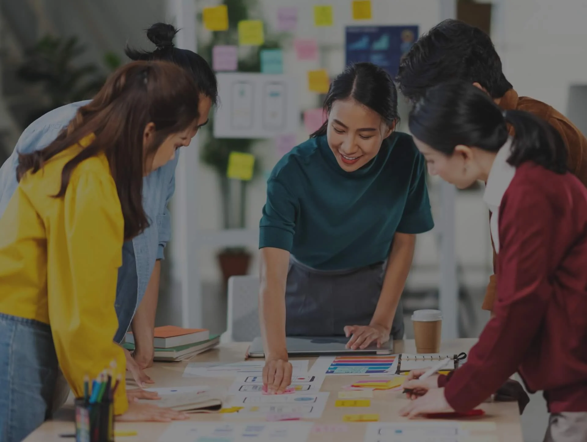 Team collaborating on web application designs, showcasing Custom Web Application Development services for efficient web-based solutions.