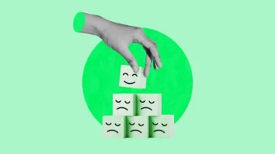 Hand stacking cubes with happy and sad faces, representing customer feedback analysis by an online marketing service provider