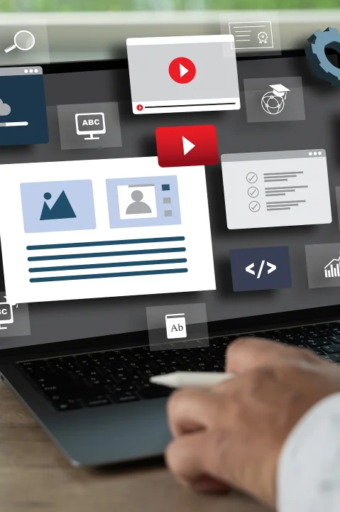 Service digital marketing image showing a hand interacting with a laptop displaying various digital marketing tools and icons, such as video, coding, and analytics