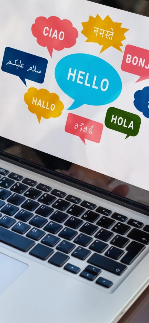 person interacting with a screen displaying multiple language greetings, representing PIM Implementation Services and Pimcore digital asset management for global content management