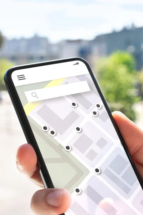 Person holding a smartphone with a map, showcasing location-based services of local SEO by a good seo company 