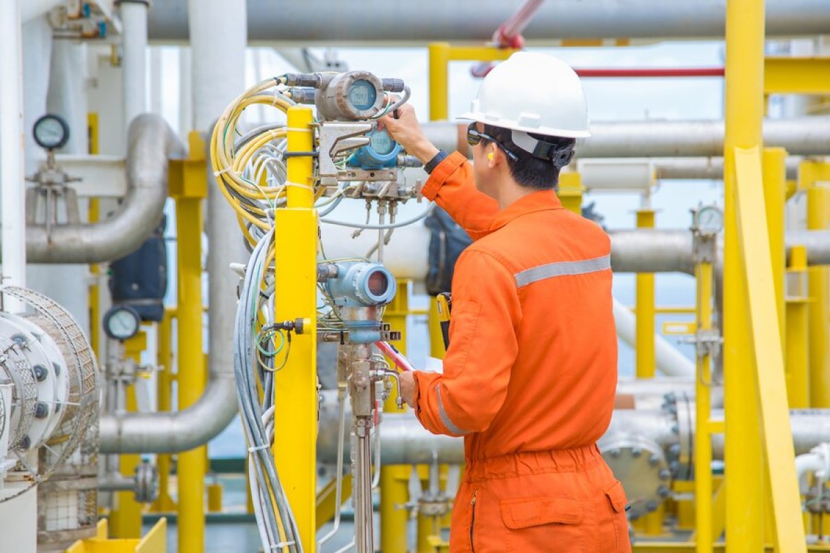 Oil and gas industry worker inspecting equipment