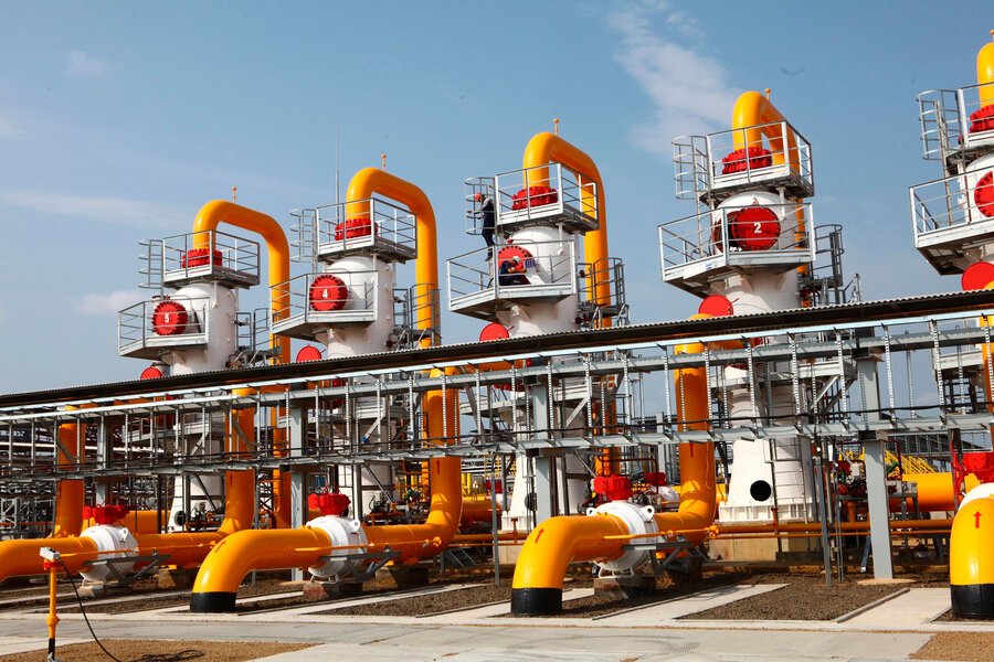 Oil and gas industrial processing units with bright yellow pipelines and machinery
